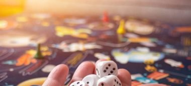 board games concept. Dice, chips and cards on the background of the playing field copy space