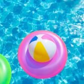 inflatable pool with swimming ring and rings in a water on blue background in the summer day.
